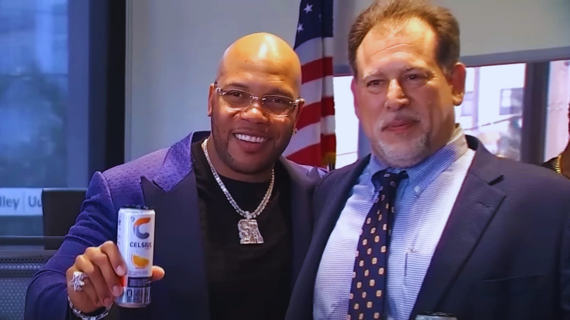 Flo Rida posing with a Celsius energy drink can after winning the lawsuit
        