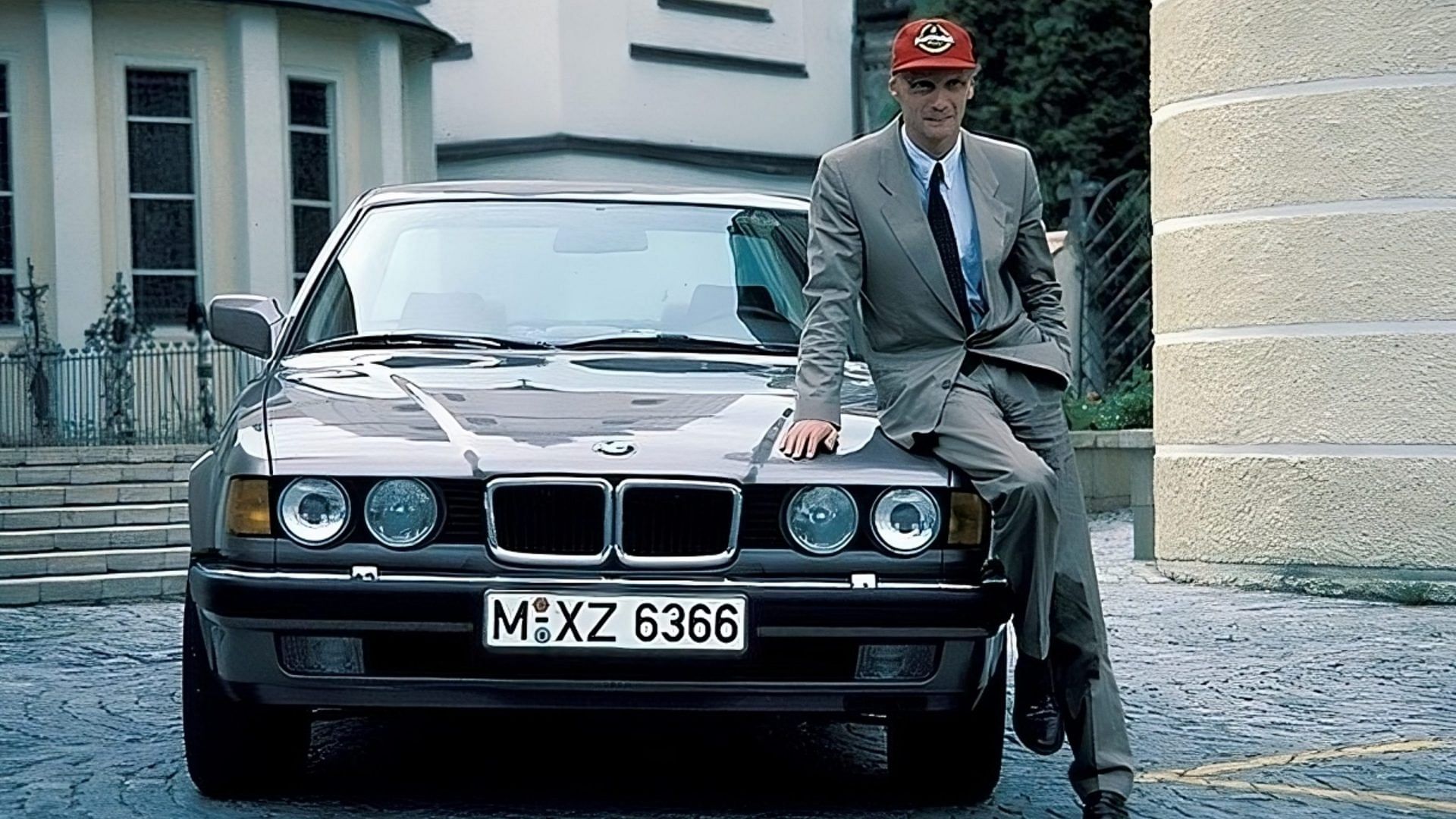 Niki Lauda standing with his silver 1987 E32 BMW 750iL