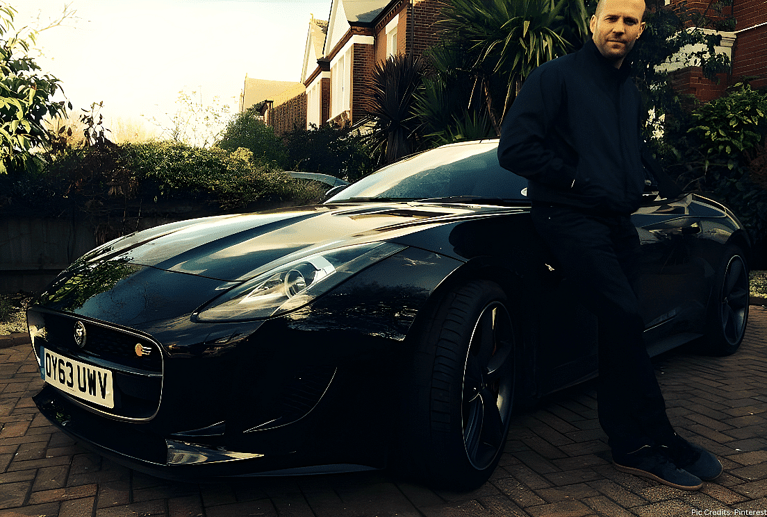 Jason Statham posing with his Jaguar F-Type