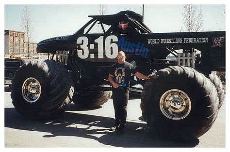 Steve Austin posing with his black Monster Truck