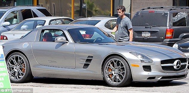 Patrick Dempsey getting into his Mercedes-Benz SLS AMG Gullwing