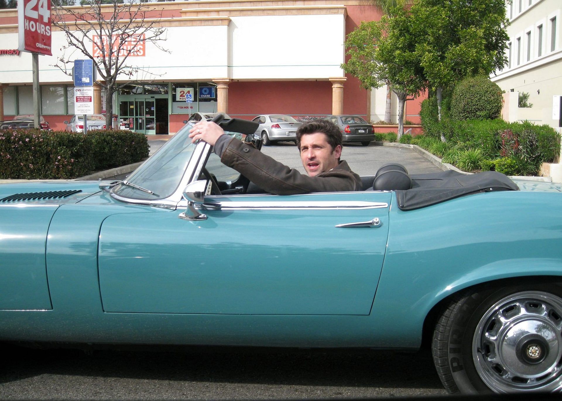 Patrick Dempsey driving his blue Jaguar E-Type Coupe