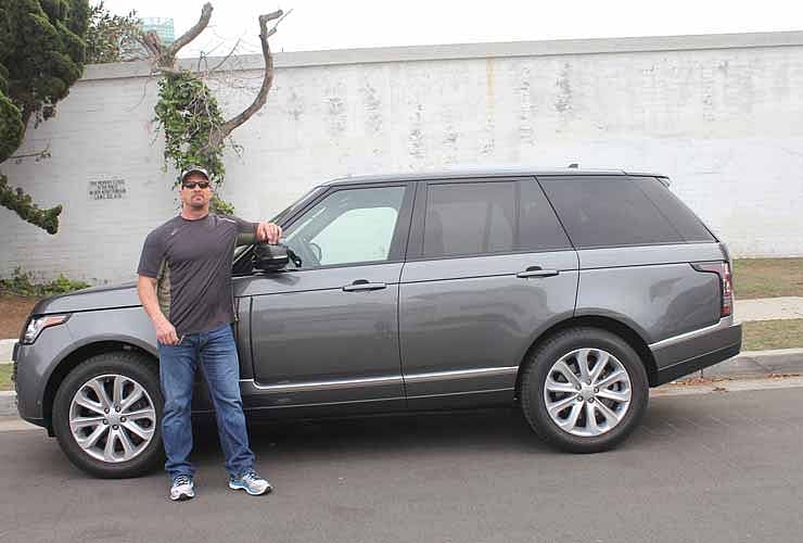 Steve Austin posing with his gray 2016 Range Rover