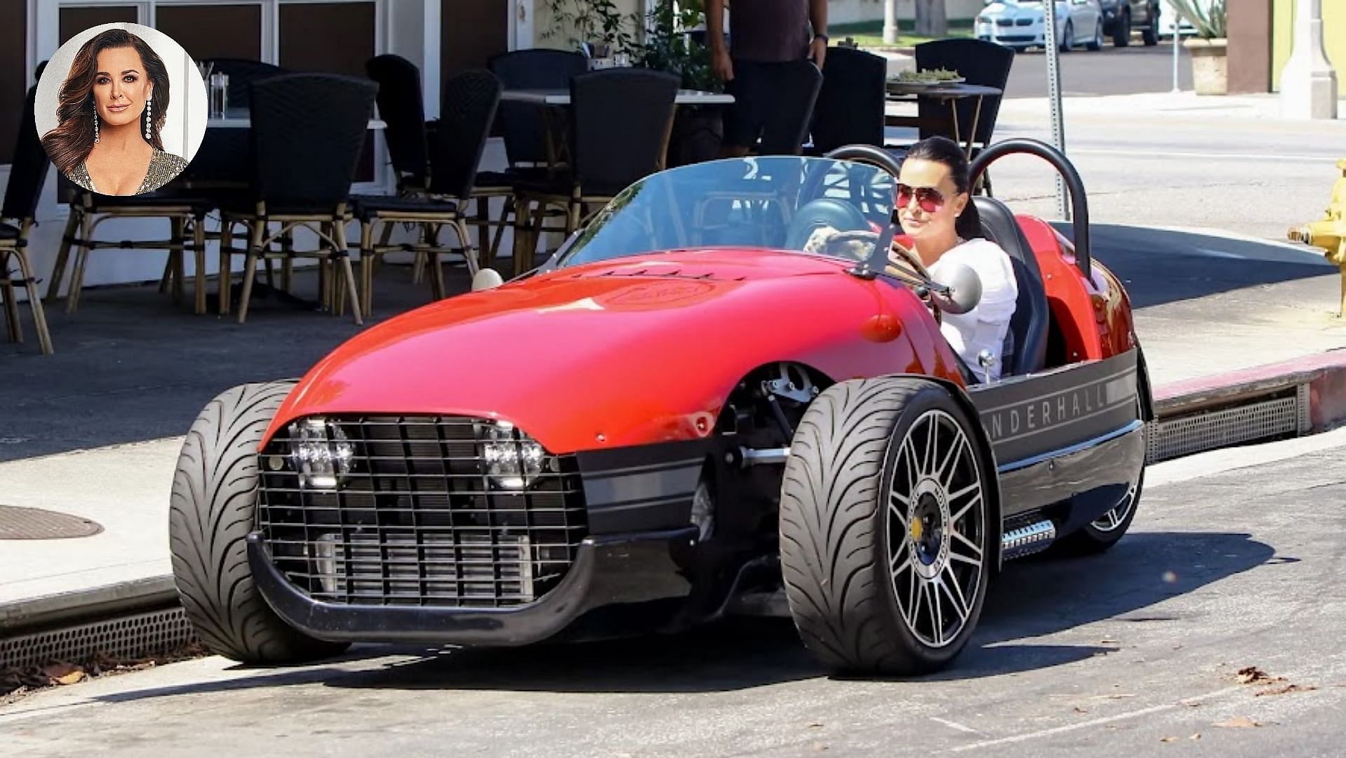 Kyle Richards driving her red Vanderhall Carmel Roadster